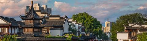 Una vista panorámica de un paisaje urbano con arquitectura tradicional china y edificios modernos al fondo.