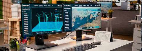Monitores con gráficos relacionados con energía eólica y paisajes naturales.